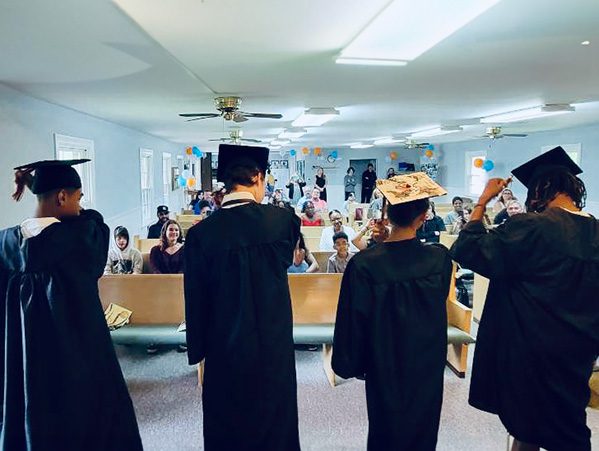 Members of the Coastal Preparatory Class of 2022 stand before the crowd for the turning of their tassels.