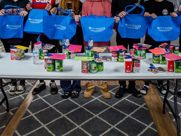 Coastal Prep students holding donation bags to be given to a local food bank. Students’ identities are protected for their privacy.